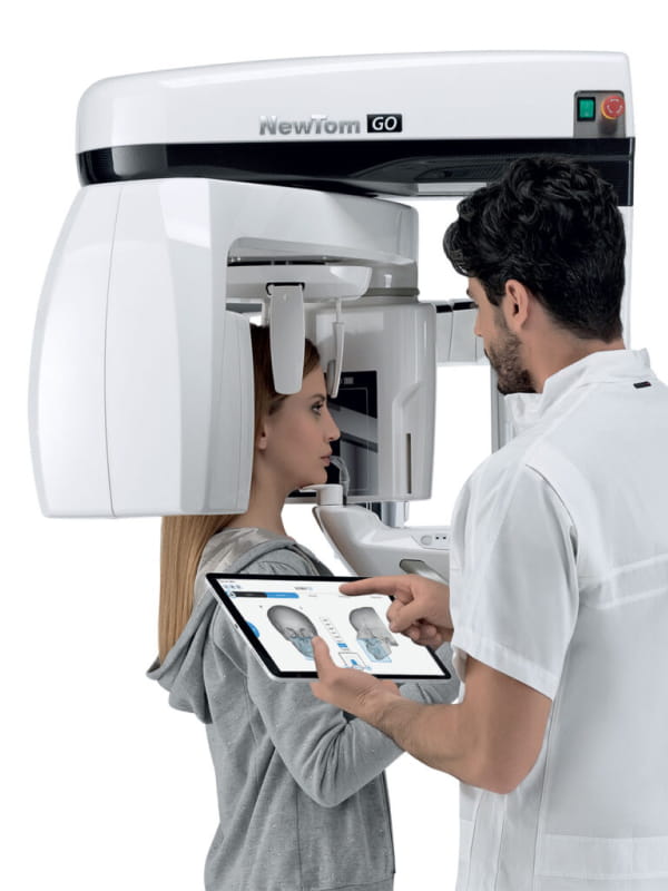 dental implant patient model getting a scan with a newtom go cbct scanner
