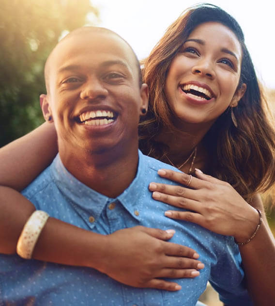 invisalign patient models smiling and embracing outside